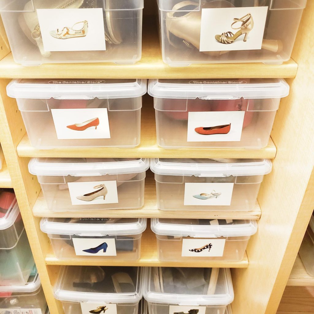 Shoes stored in plastic boxes on a shelf