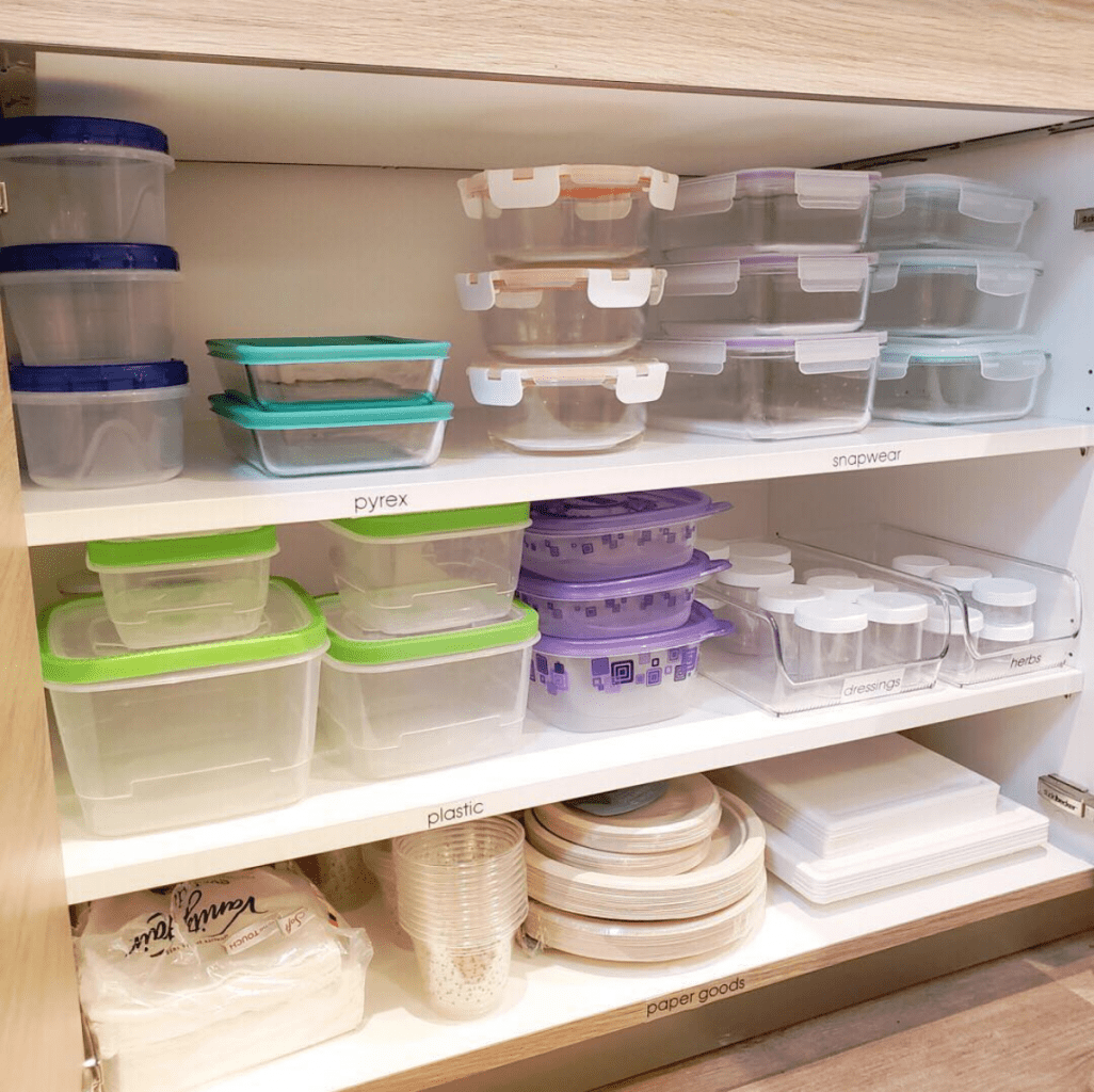 A kitchen cabinet filled with a multitude of plastic containers, delegated for storage.