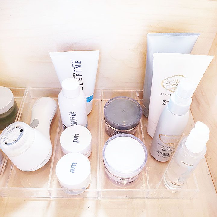 Organize your makeup with beauty products in a clear container on a shelf.