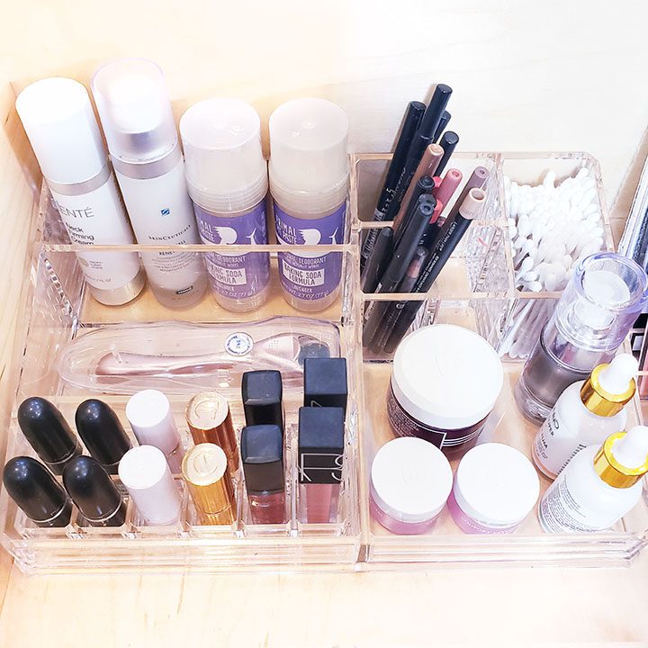A [clear] makeup organizer with a variety of cosmetics, perfect to [organize your makeup].