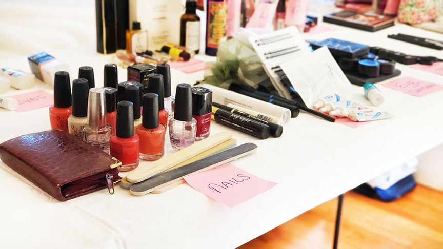 An organized table with nail polishes and other cosmetics.