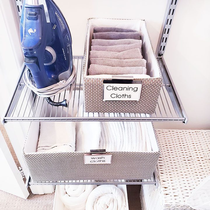 A laundry room with a steam iron and cleaning supplies, perfect for helping you organize your linen closet.