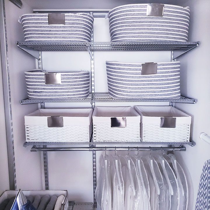 A closet full of organized laundry baskets and baskets for your linen.