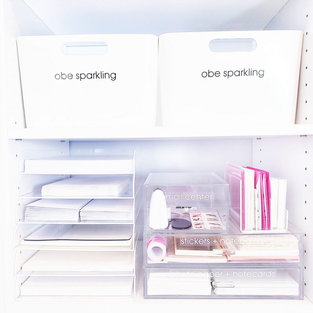 A white closet with a variety of bins and folders to help you organize your desktop.