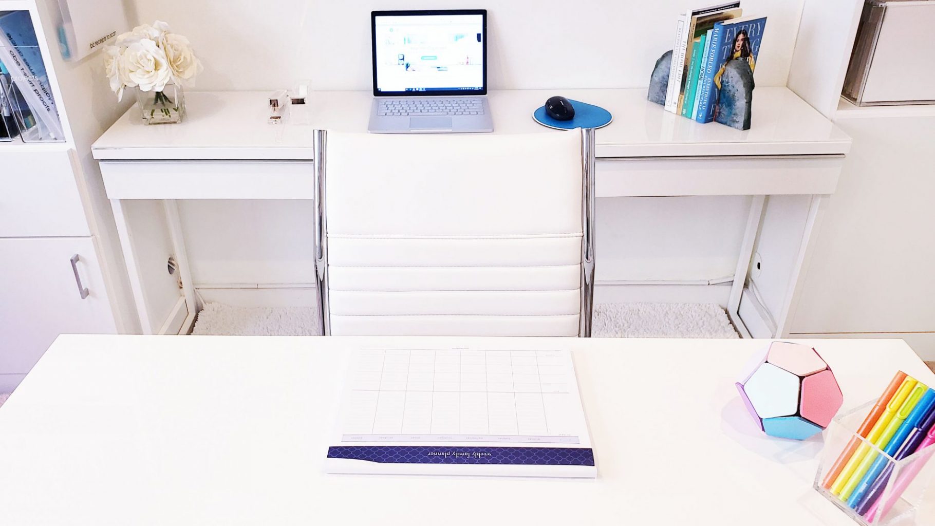 Use your white desk to organize your desktop with a laptop and pens.