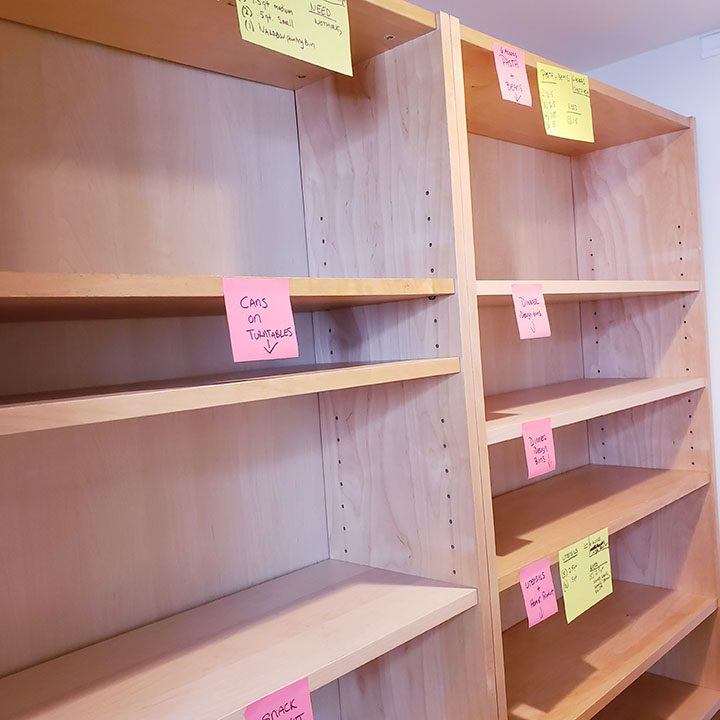 A pantry filled with shelves covered in sticky notes.