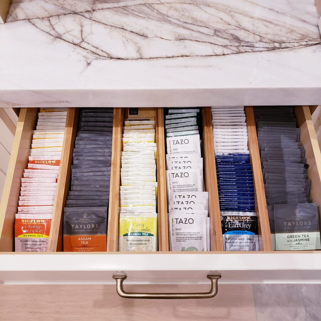 A kitchen drawer filled with a tea collection.