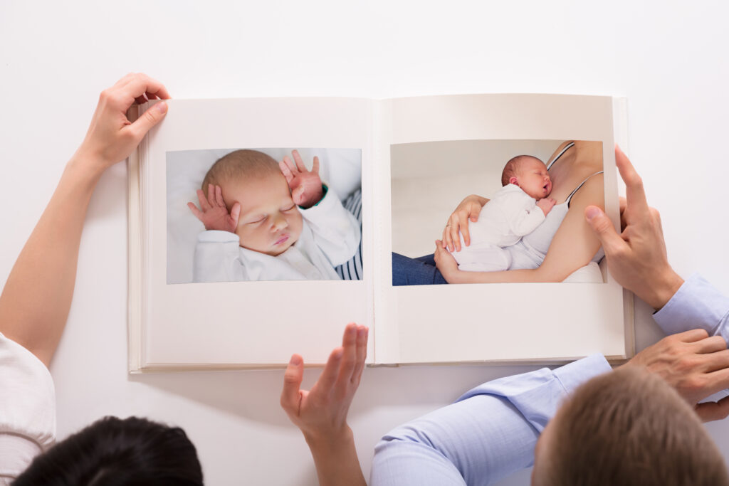 A photo of a family holding photos of a baby. Organized keepsakes