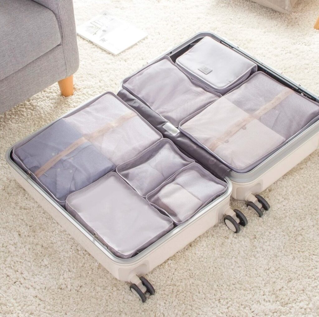 A set of luggage designed for Spring Break, featuring multiple compartments on the floor.