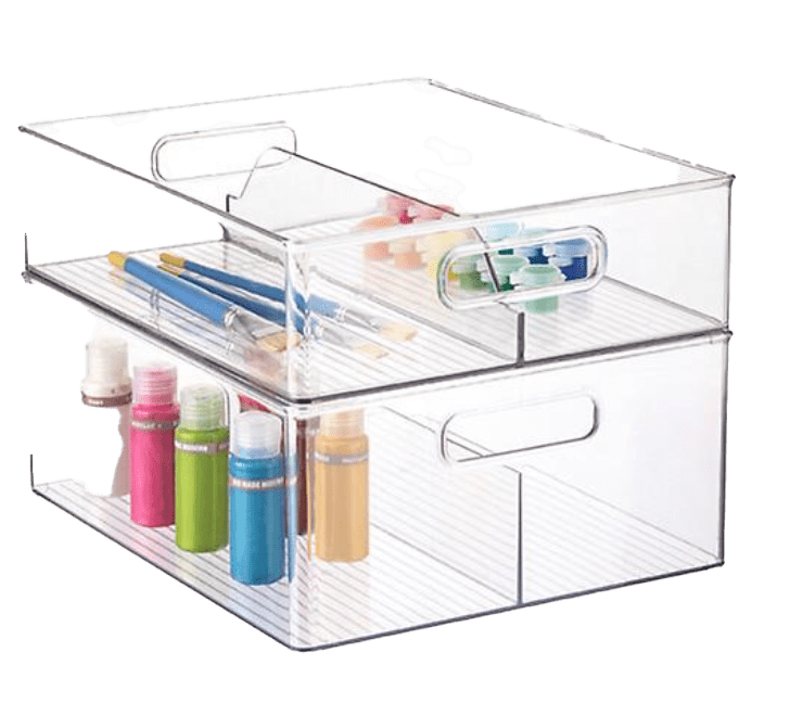 A clear plastic storage box with pens and pencils.