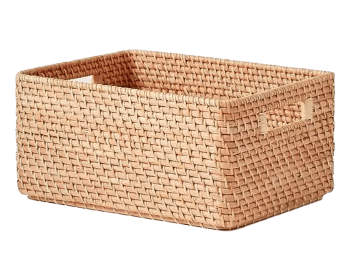 A woven basket with handles on a white background.