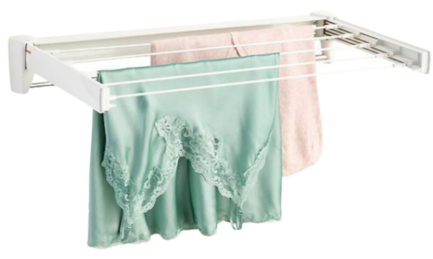 A white clothes rack with clothes hanging on it.