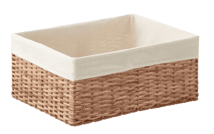 A wicker basket with a white cover.