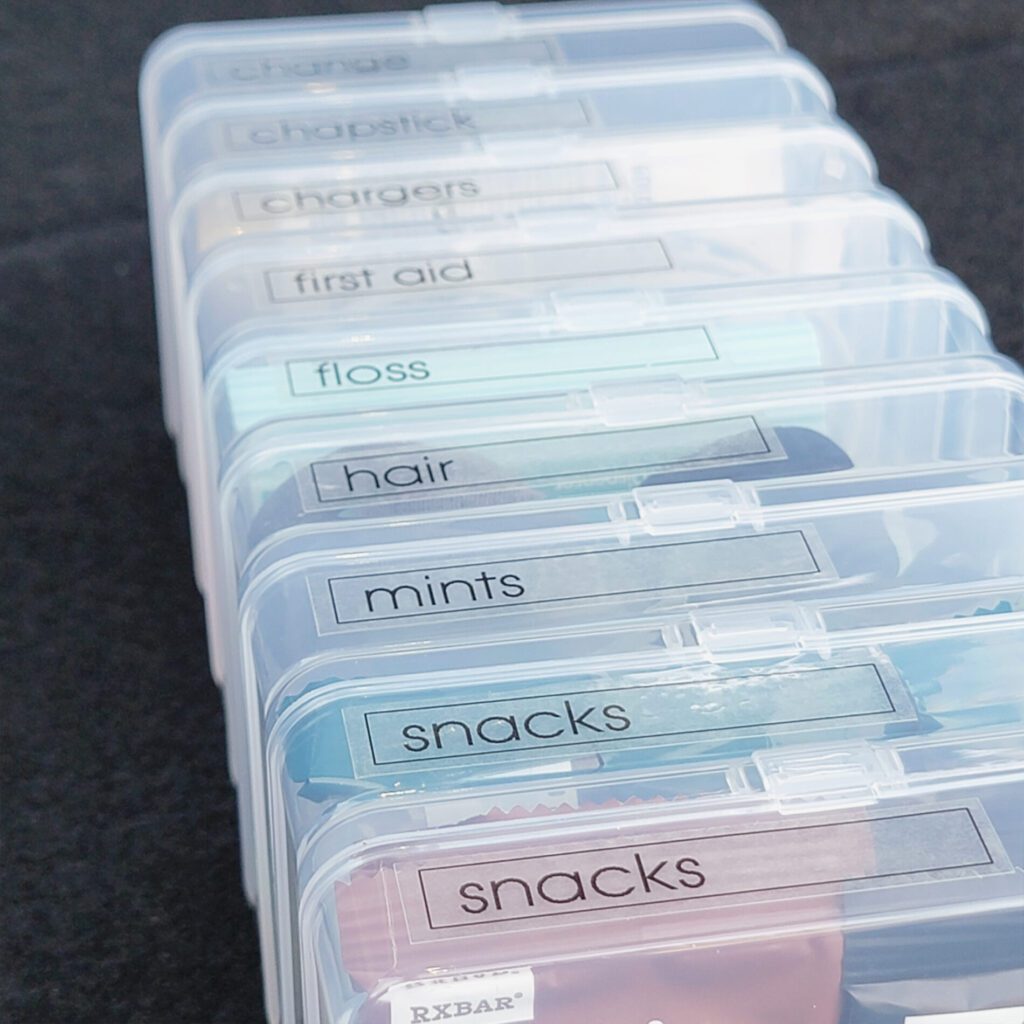 A stack of clear plastic containers with snacks in them, perfect for on-the-go snacking in the car.