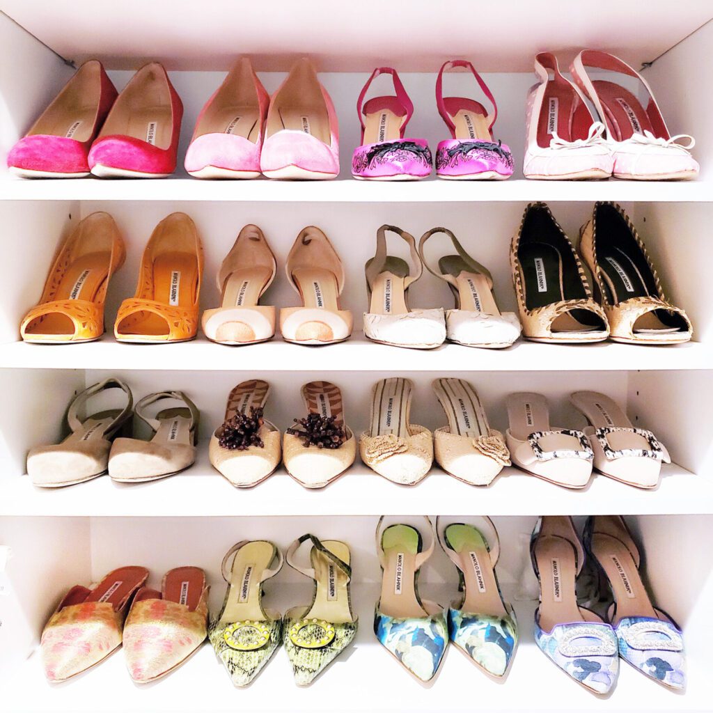 A decluttering effort left a closet full of shoes in different colors.