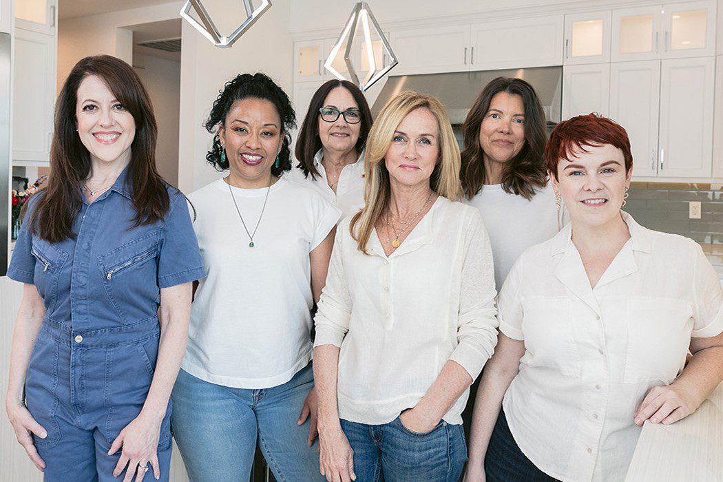 group of women organizers in an organized white kitchen