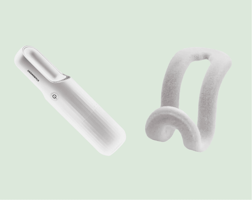 White handheld vacuum and curved accessory.