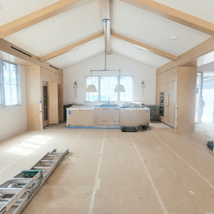Renovated room with wooden beams and flooring.