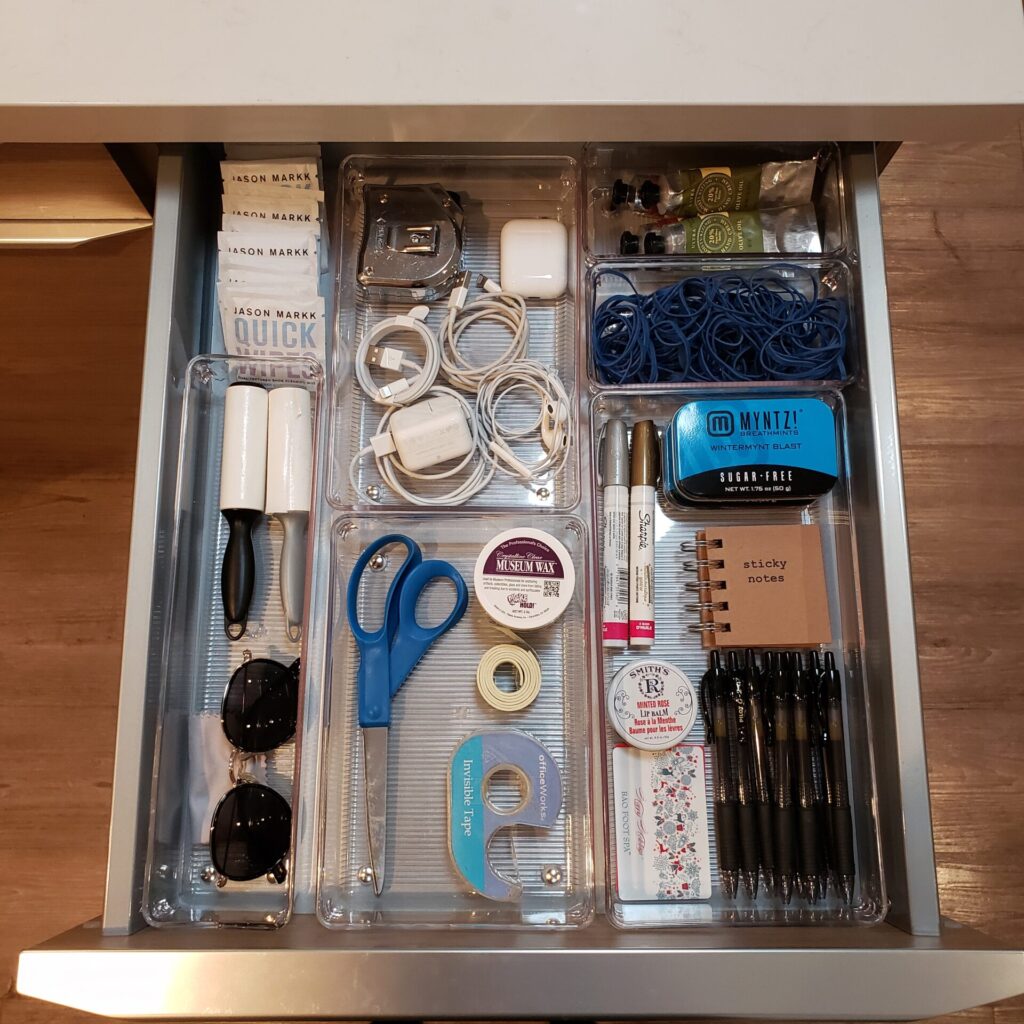 Organized drawer with various office supplies.