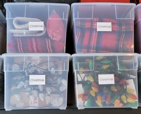 Labeled storage bins for Christmas decorations.